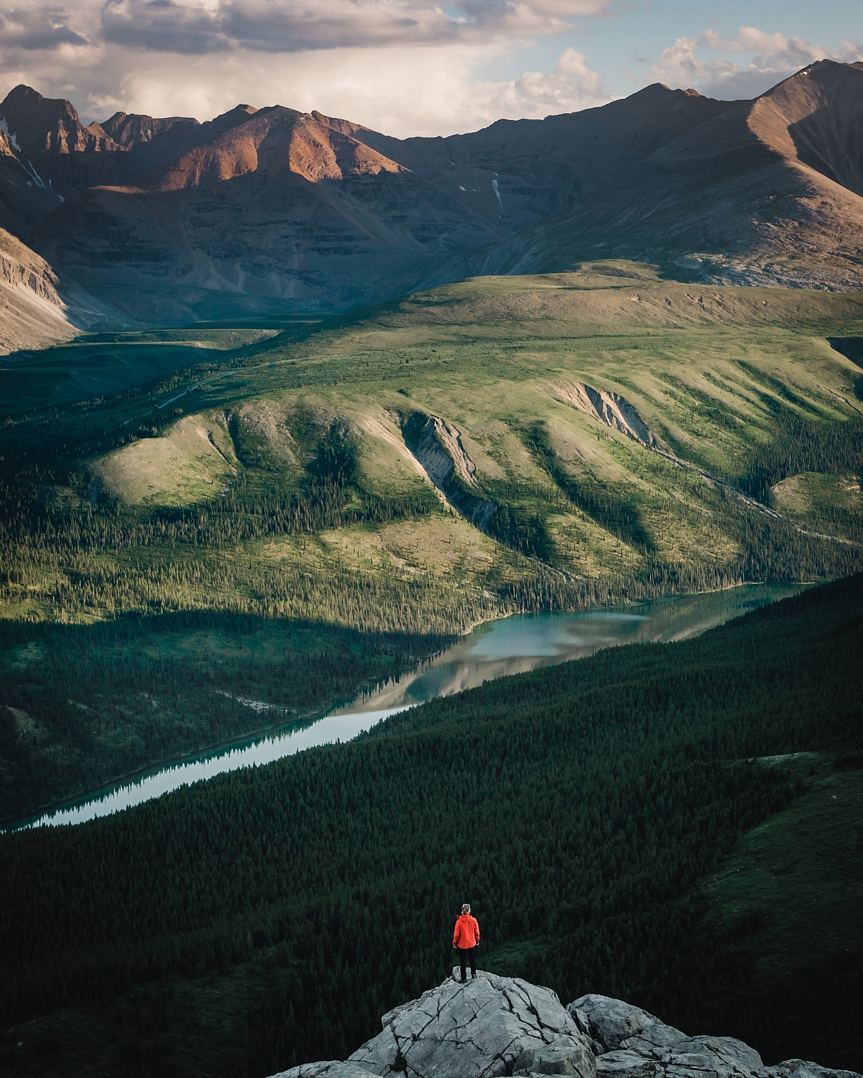 Hiker overlooking the vast valley in Stone Mountain Provincial Park.