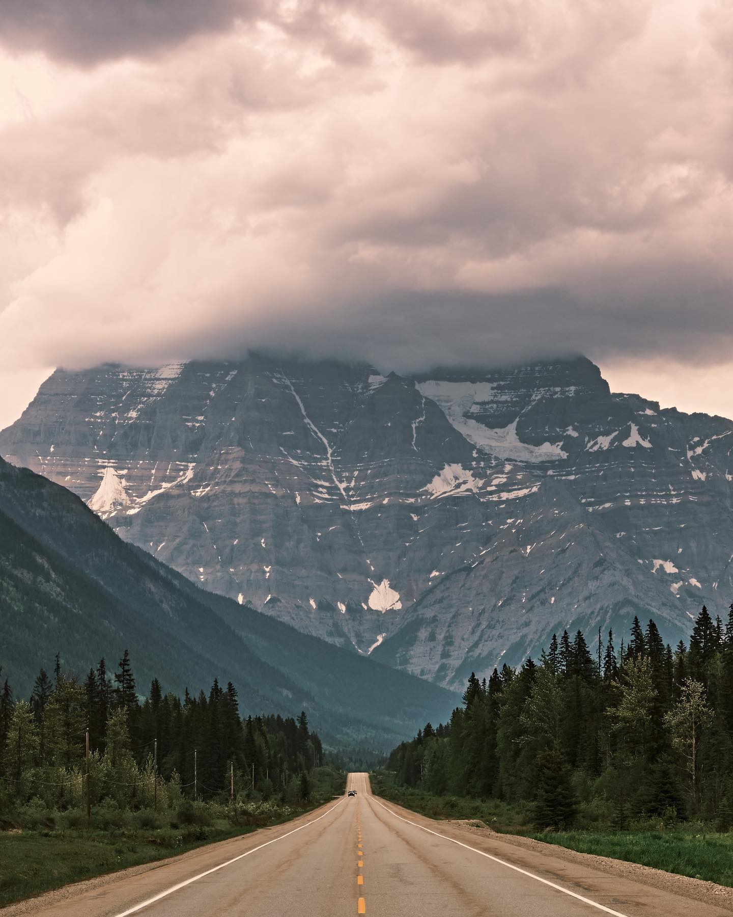 photo by pics_by_reece caption reads: • Canadian Pavement • 
One of the highlights of Canada’s highways is driving through the Rockies. The mountain featured in this photo is Mount Robson and being one of the most prominent mountains in the range, it is jaw dropping. 
Shot on fujifilmx_ca XT4 and fujinonlenses 18-55mm f/2.8-4.0 
• 1/220s • f/16 • ISO 800 • 
Edited with captureonepro 
#hellobc #bcparks #editwithus #explorecanada #canadatravel #canadavisuals #exploretocreate #getoutside #fujifilm_canada #albertabound #mountains #highway #cangeo #cangeotravel #highwayphotography 
hellobc yourbcparks parks fujixlovers fujifilm.focus _fujilove_ explorecanada tourcanada cangeo cangeotravel canadavisuals shotsofcanada