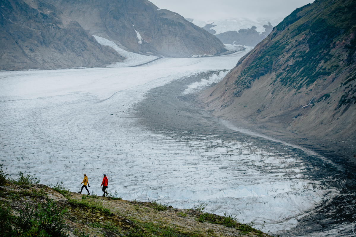 two people hiking along a mountain ridge